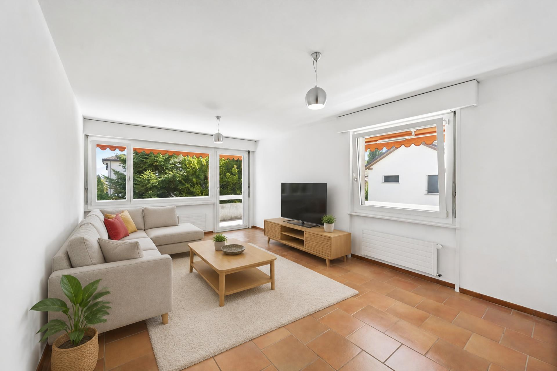 Apartment in Prilly — bright living room opening onto the balcony-terrace